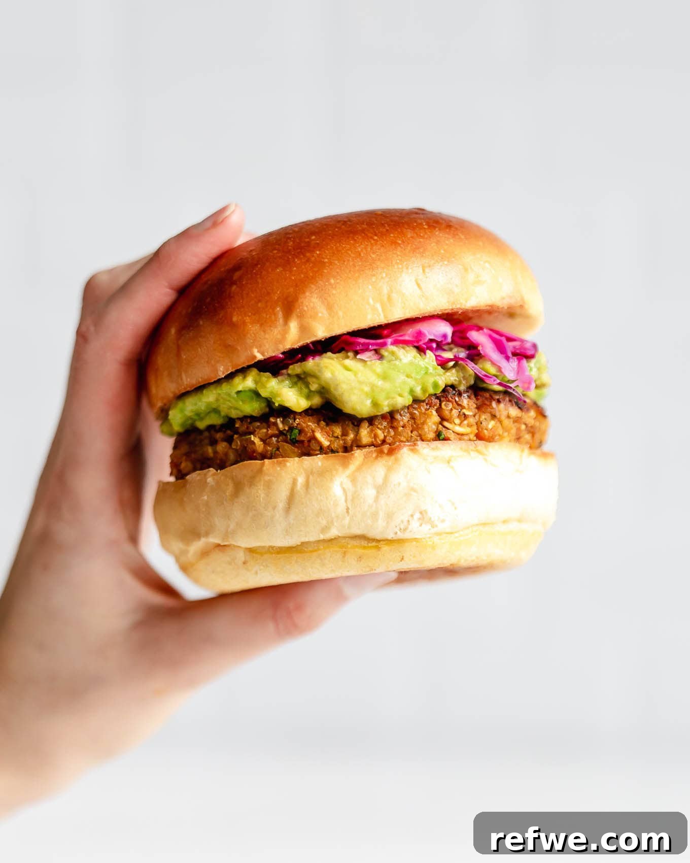 Your New Favorite Chickpea Burgers 2 A hand holding a perfectly grilled chickpea veggie burger, showcasing its rich texture and wholesome ingredients.