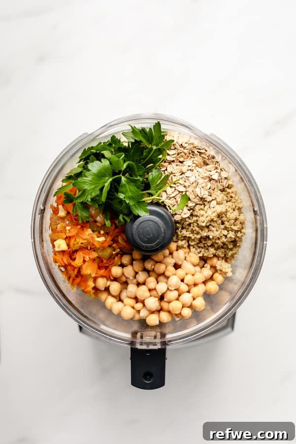Your New Favorite Chickpea Burgers 6 All the chickpea veggie burger ingredients loaded into a food processor, ready for blending.