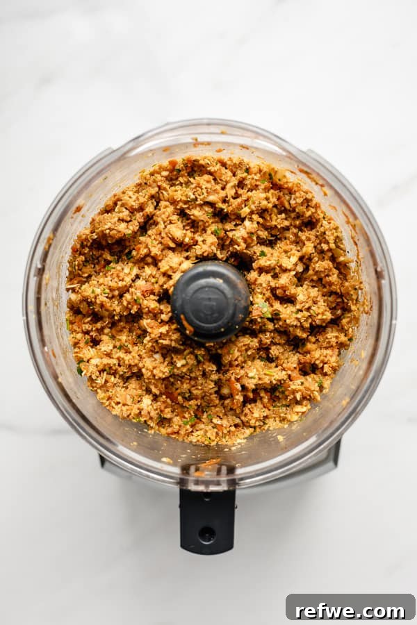 Your New Favorite Chickpea Burgers 7 The perfectly pulsed chickpea veggie burger mixture in a food processor, showing its ideal texture.