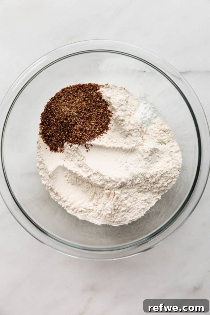 Oat flour, ground flax seeds, baking powder, baking soda, and salt mixed in a separate large bowl.