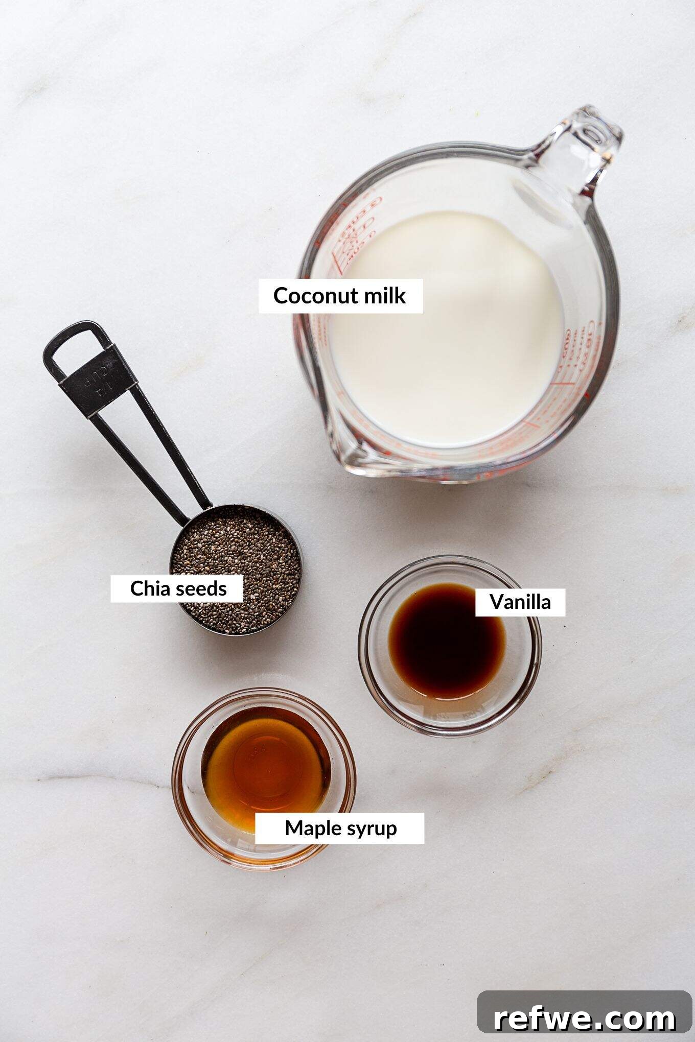 Creamy Vanilla Chia Delight 3 A flat lay image showing the simple ingredients required for vanilla chia pudding: chia seeds, milk, vanilla extract, and maple syrup.