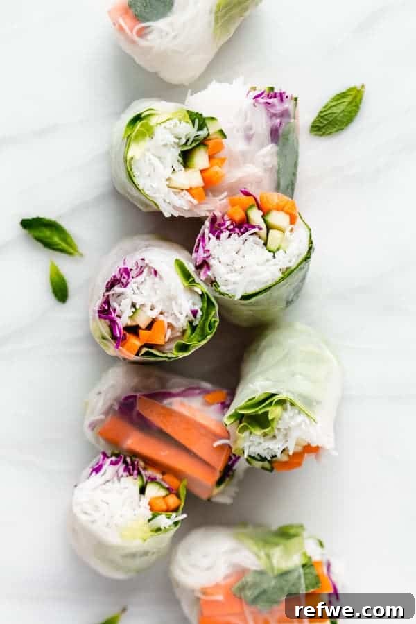 Summer Rolls 2 Vibrant Vietnamese fresh spring rolls elegantly arranged on a marble board, ready to be enjoyed with dipping sauce.