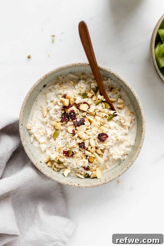 Tropical Coconut Cashew Bircher 5 A delicious bowl of Bircher muesli generously topped with crunchy chopped cashews, sweet dried cranberries, and delicate shredded coconut, ready to be enjoyed.