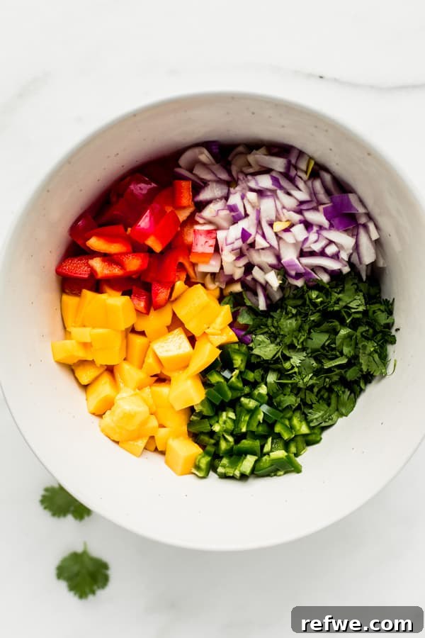 Ferah ve Pratik Mango Salsa 4 A large mixing bowl with neatly piled mango salsa ingredients before they are combined.