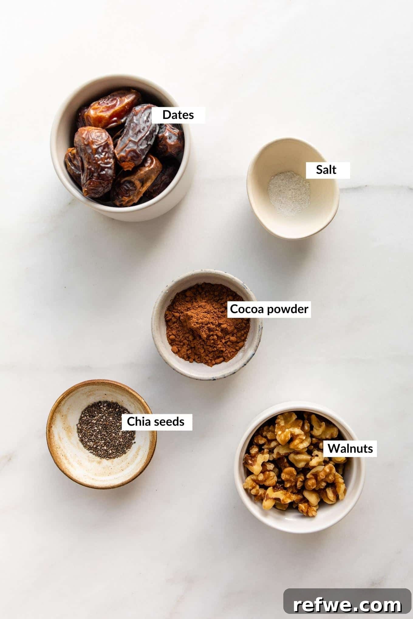 Fudgy Date & Chocolate Bites 3 A selection of the 5 key ingredients laid out: Medjool dates, walnuts, cocoa powder, chia seeds, and a pinch of salt.