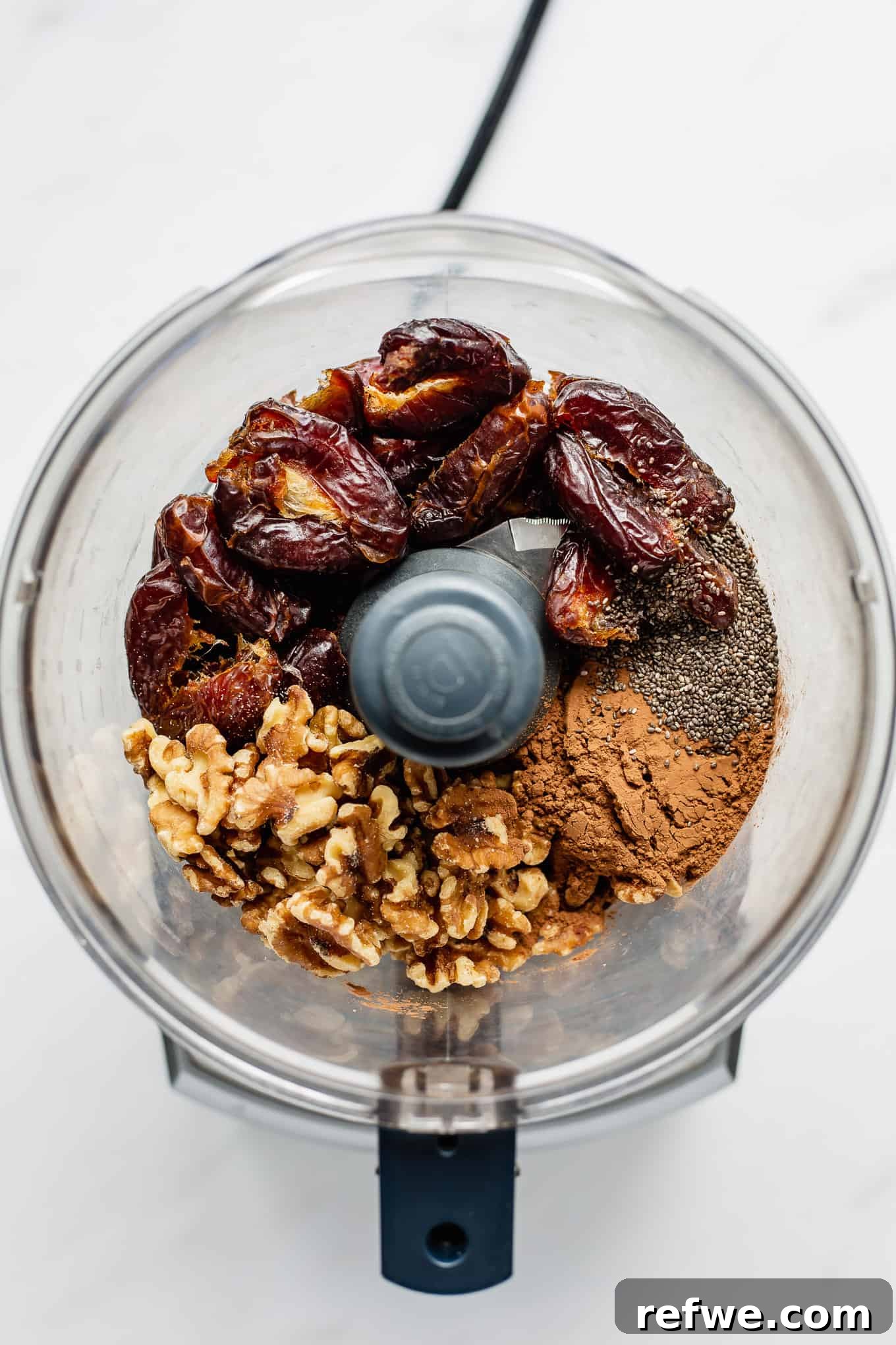Fudgy Date & Chocolate Bites 4 Medjool dates, walnuts, cocoa powder, and chia seeds ready in a food processor bowl before blending.