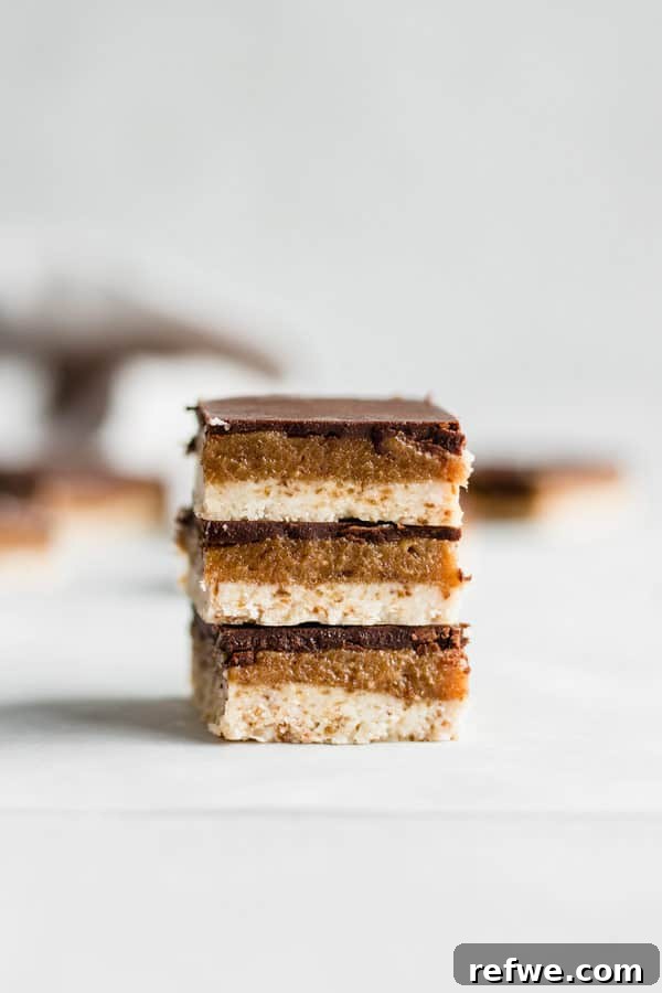 Effortless Oven-Free Sweet Treats 3 Close-up of a raw salted caramel slice, showing distinct layers of crust, caramel, and chocolate topping.