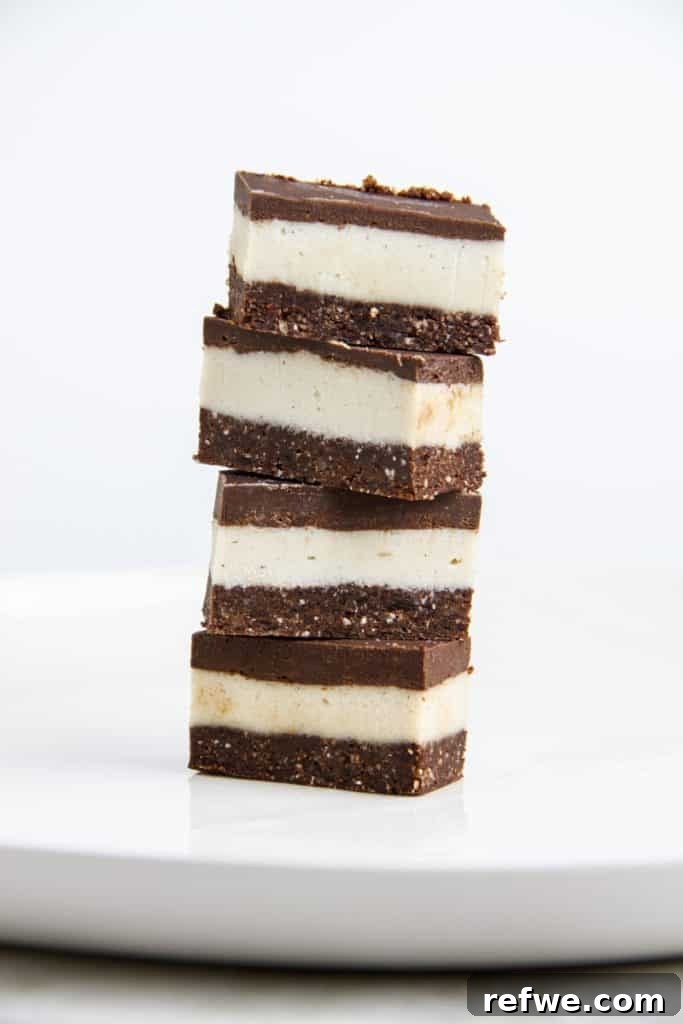 Effortless Oven-Free Sweet Treats 10 A stack of four raw chocolate peppermint bars, showing distinct green peppermint and dark chocolate layers.