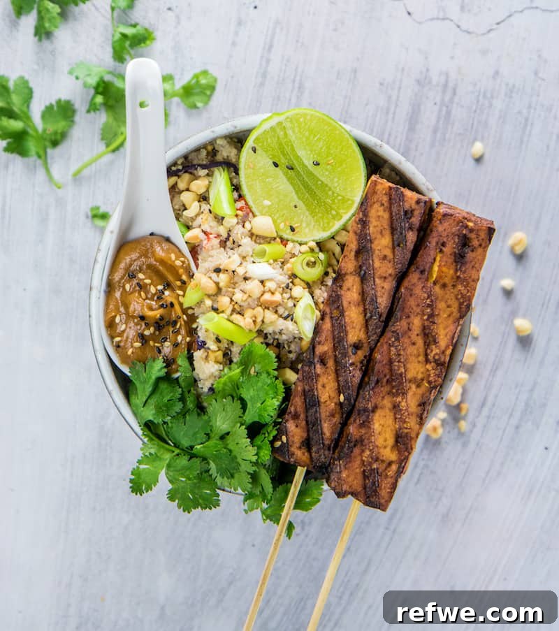 Flavorful Tofu Satay and Cauliflower Fried Rice 2 Delicious Tofu Satay skewers served with a side of cauliflower fried rice and peanut sauce
