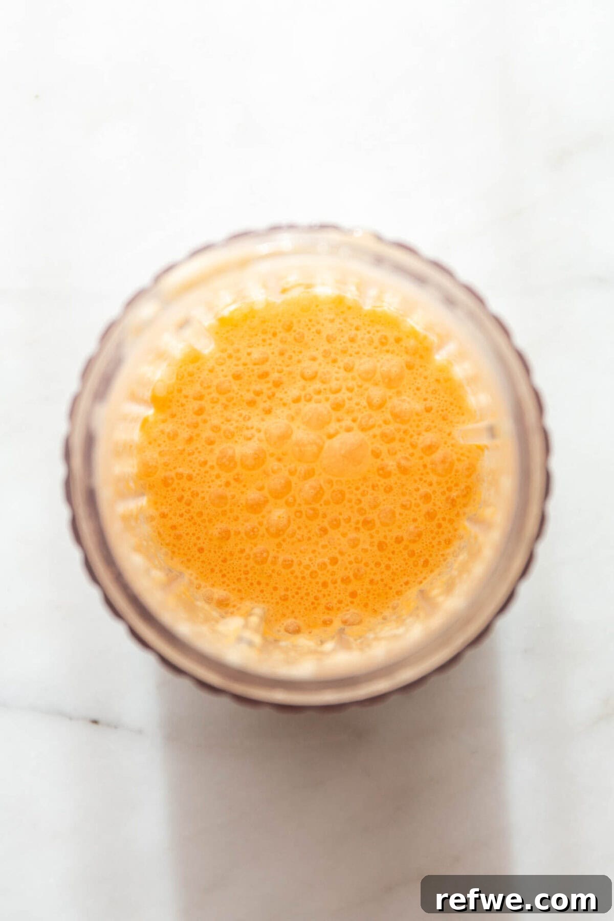 Silky Orange Dream Chia Pudding 5 The orange segments, coconut milk, vanilla, and maple syrup are now smoothly blended in the blender container.