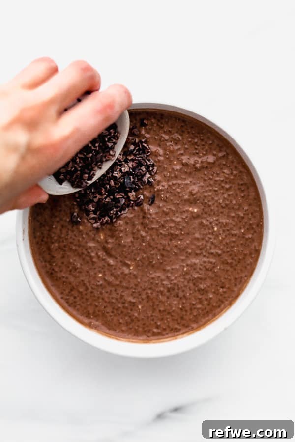 Decadent Chocolate Raspberry Chia Pudding 5 A close-up shot of the chocolate chia pudding mixture in a clear bowl, showing its readiness to be chilled and set.