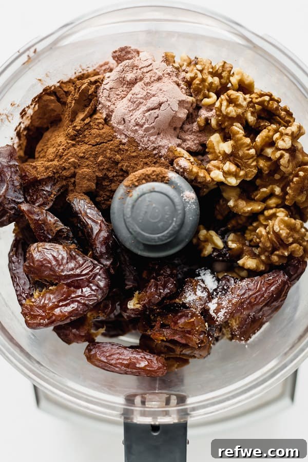 Decadent No-Bake Fudge Brownies 4 a food processor with ingredients for no bake brownies in it
