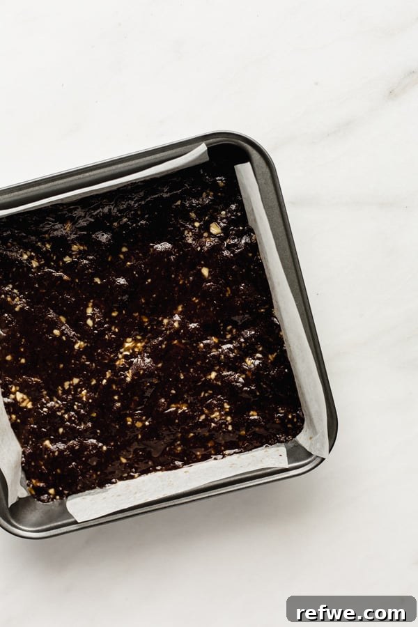 Decadent No-Bake Fudge Brownies 6 no bake brownies in a silver 8x8 inch baking pan