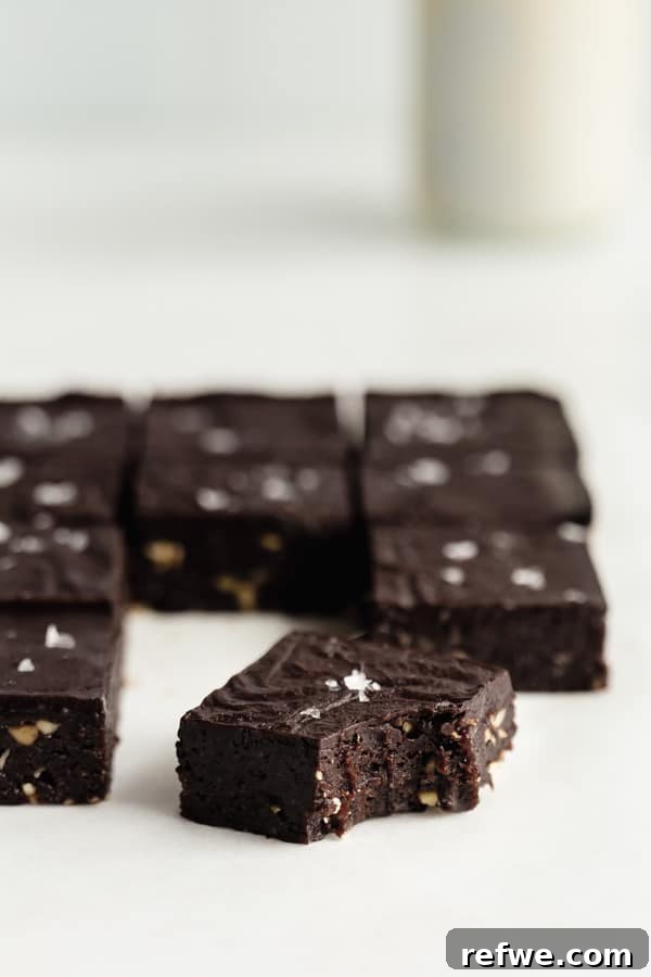 Decadent No-Bake Fudge Brownies 9 a no bake brownie with a bite taken out of it topped with sea salt