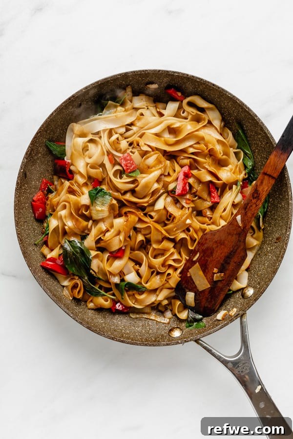 25 Delicious Vegan Dinners Made Easy 13 Freshly stir-fried Thai Drunken Noodles with vegetables and herbs in a pan
