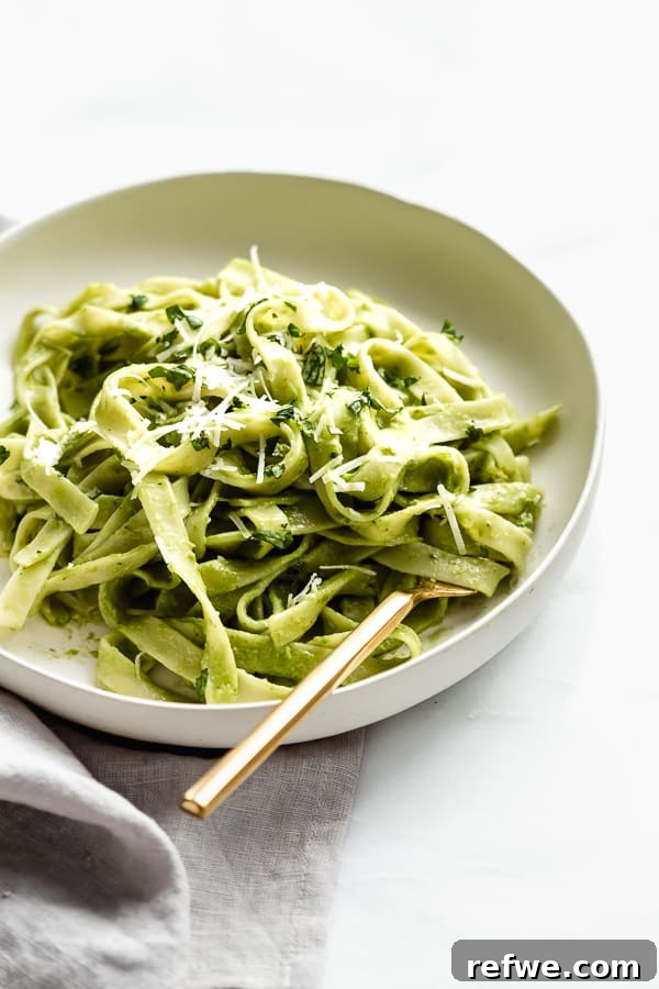 25 Delicious Vegan Dinners Made Easy 10 Luscious Creamy Avocado Pasta in a bowl, garnished with fresh herbs