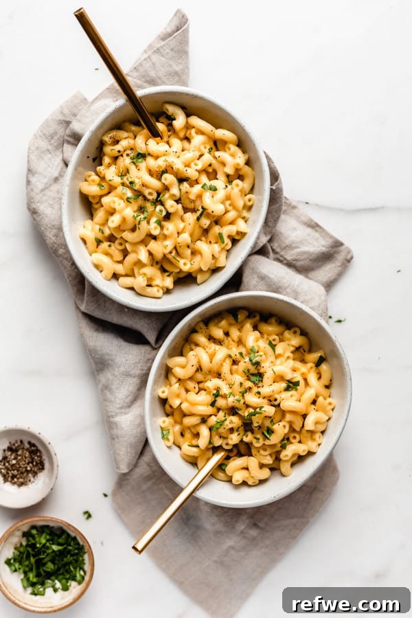 Quick Creamy Instant Pot Mac and Cheese 3 two bowls of mac and cheese on a taupe coloured napkin