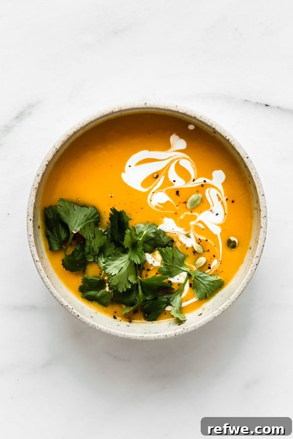 Golden Butternut Instant Pot Comfort 8 a bowl of butternut squash soup topped with cilantro, coconut milk and pumpkin seeds