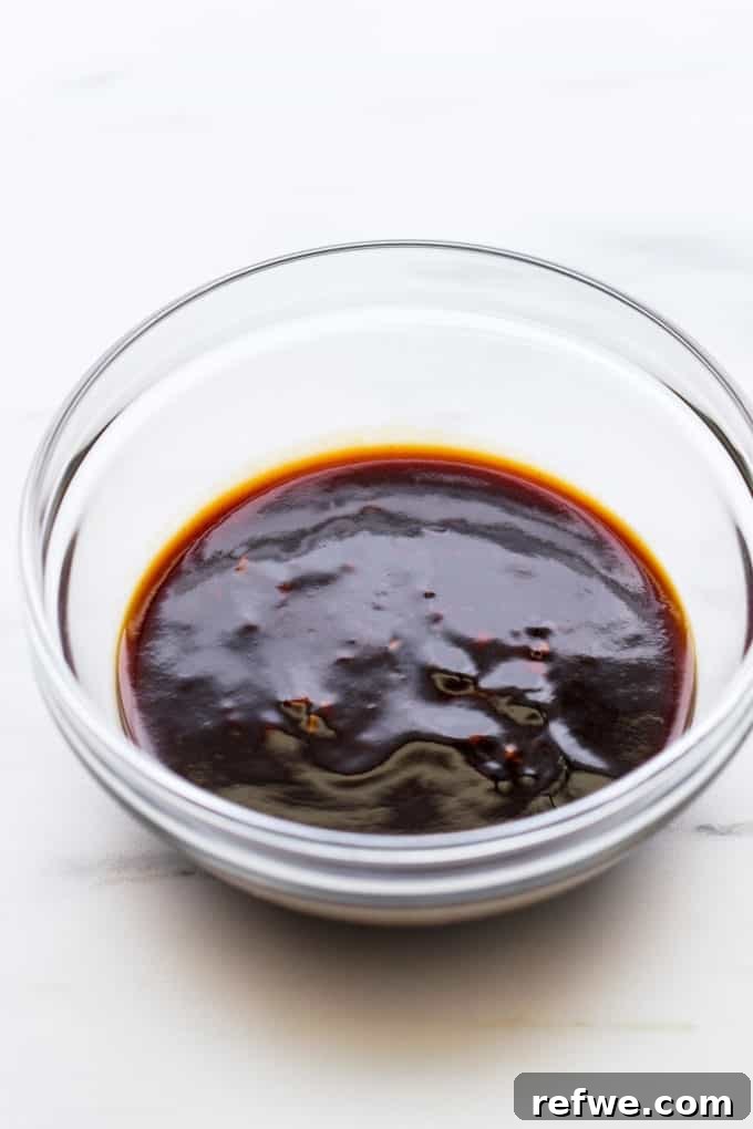 General Tso's sauce in a clear bowl, highlighting its perfect consistency and vibrant color.