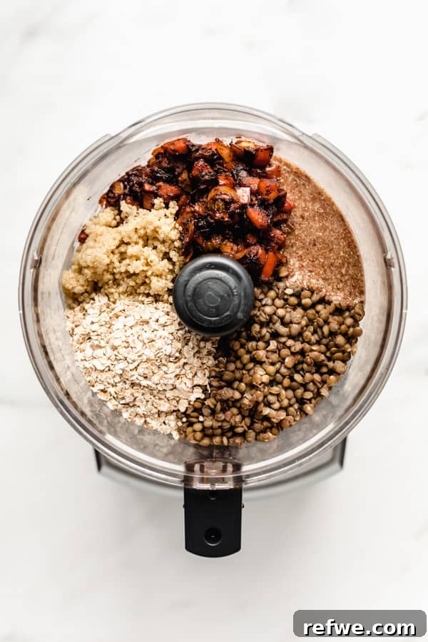 Comforting Plant-Based Lentil Loaf 3 A food processor with veggies, lentils, flax oats and quinoa in it