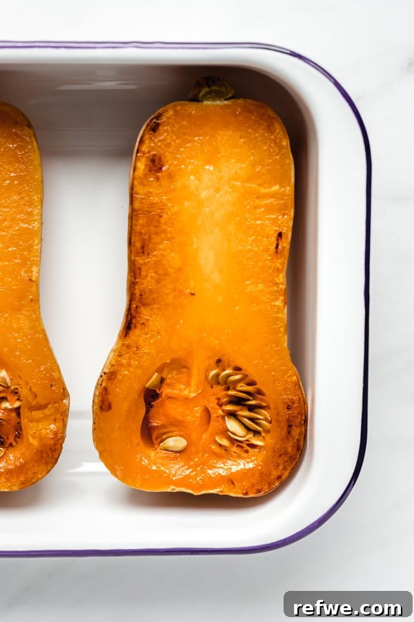 Mastering Butternut Squash Cooking 5 A whole roasted butternut squash in a white pan, golden brown and ready to be served