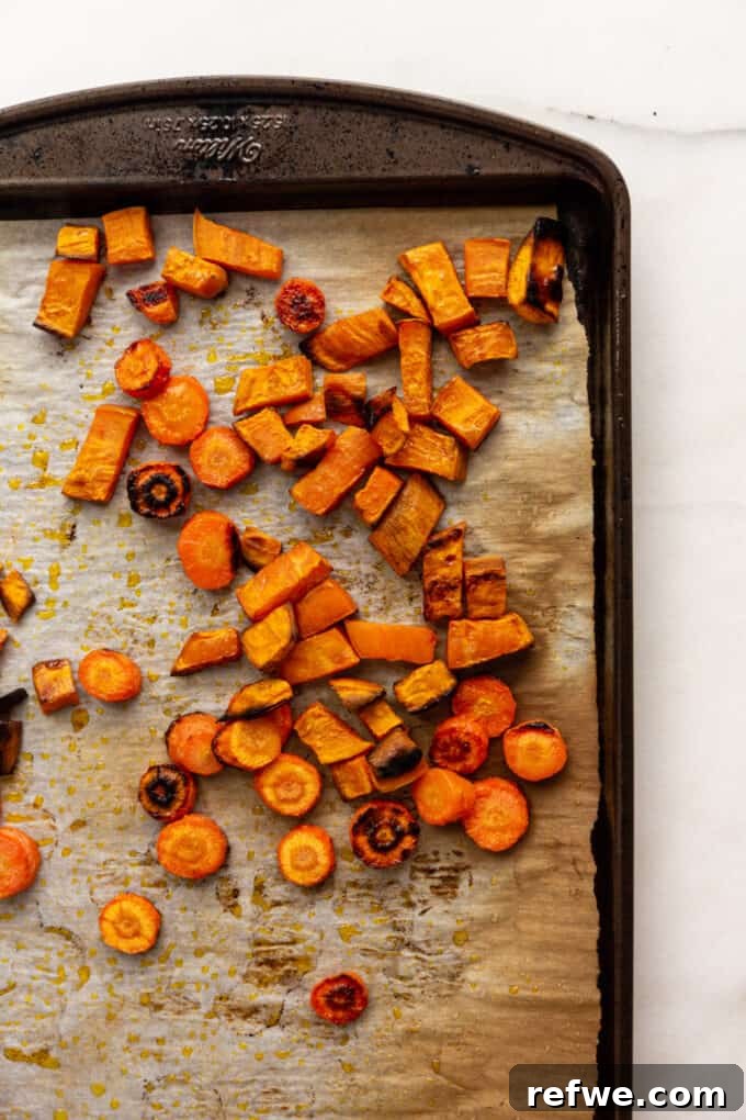 Warming Roasted Sweet Potato Carrot Ginger Soup 4 roasted sweet potatoes and carrots on a baking pan