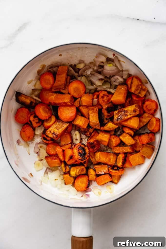 Warming Roasted Sweet Potato Carrot Ginger Soup 6 onion, garlic, ginger, roasted sweet potatoes and carrots in a pot