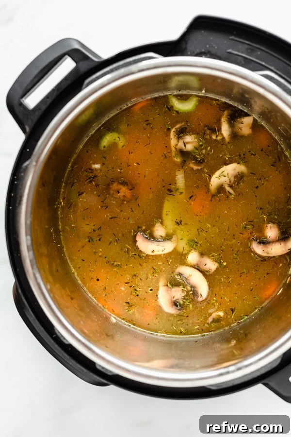 Creamy Instant Pot Wild Rice Comfort 4 Instant Pot with vegetable broth added to the sautéed vegetables and wild rice.