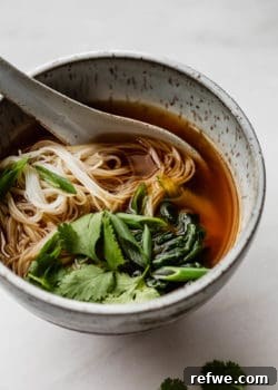 Vegan pho in a speckled blue ceramic bowl