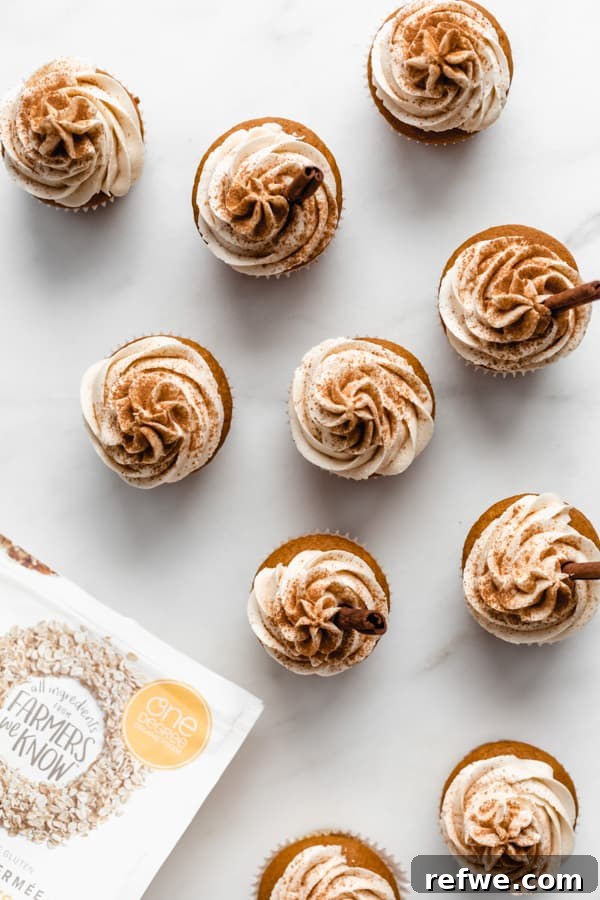 Cozy Vegan Pumpkin Spice Latte Cupcakes 5 Overhead view of several autumn-themed pumpkin cupcakes on a stylish marble serving board