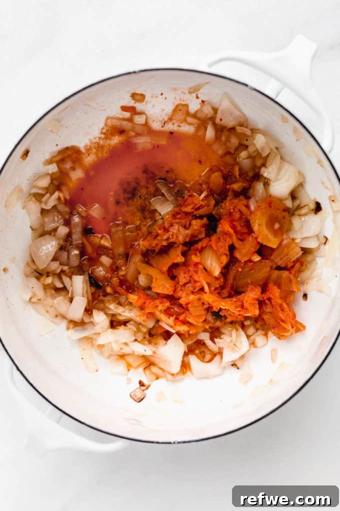 Spicy Korean Soft Tofu Stew 4 onions, garlic and kimchi in a pot