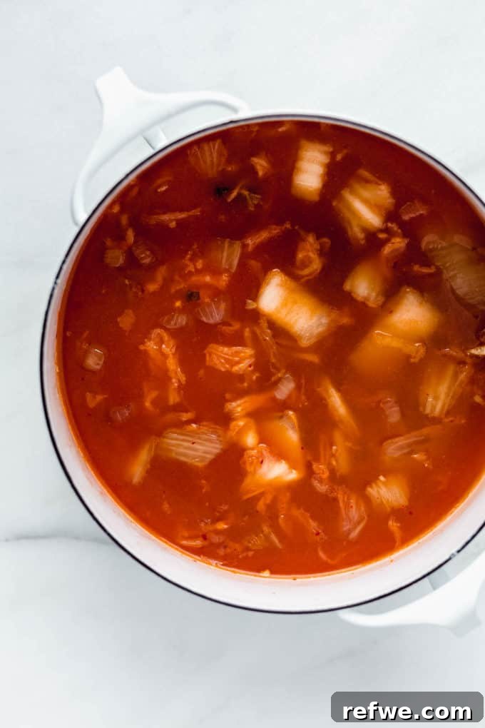 Spicy Korean Soft Tofu Stew 6 Korean Tofu Soup in a white pot on a marble board