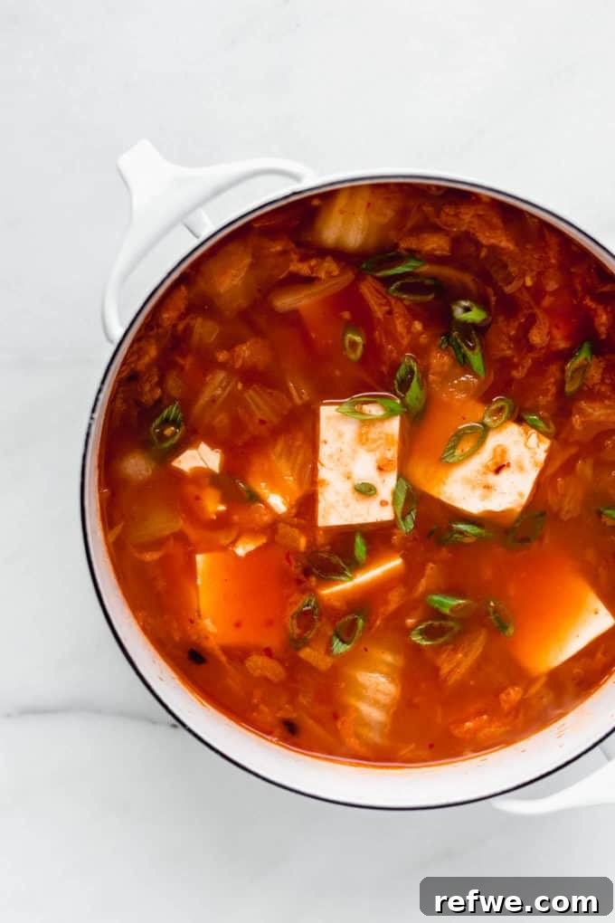 Spicy Korean Soft Tofu Stew 7 Korean Tofu Soup in a white pot topped with green onions