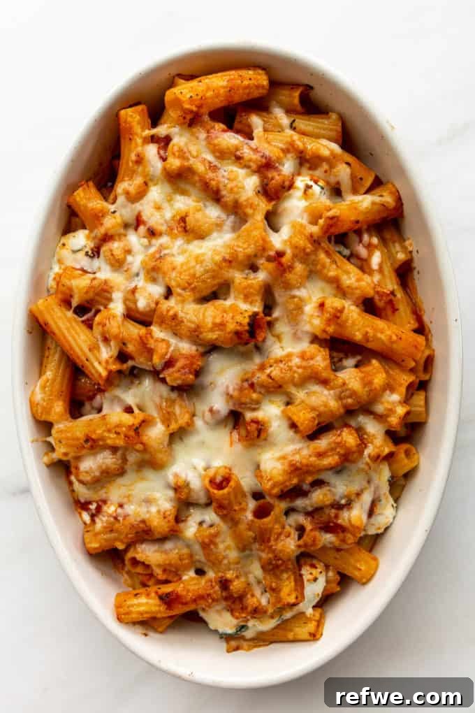 Rich Ricotta Vegetarian Ziti Bake 13 Baked ziti topped with melted cheese in a white baking dish