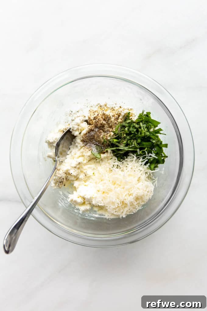 Rich Ricotta Vegetarian Ziti Bake 5 Ricotta, Parmesan and basil in a clear mixing bowl