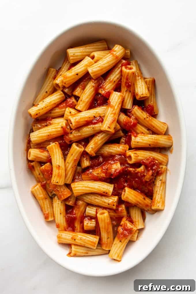Rich Ricotta Vegetarian Ziti Bake 9 ziti noodles and tomato sauce in a baking dish