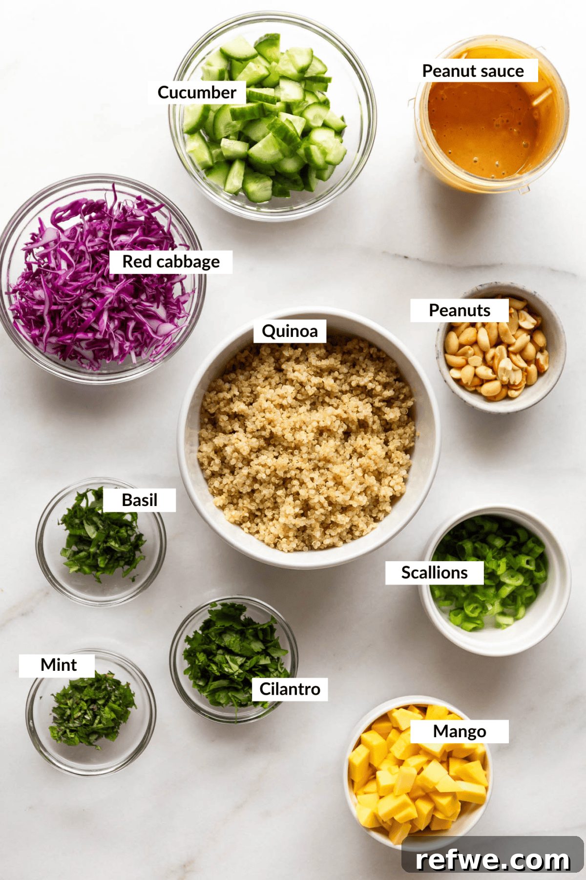 Thai Peanut Quinoa Bowl 3 A vibrant flat lay of all the fresh ingredients required to make a delicious Thai quinoa salad, showcasing the colorful vegetables, quinoa, and dressing components.