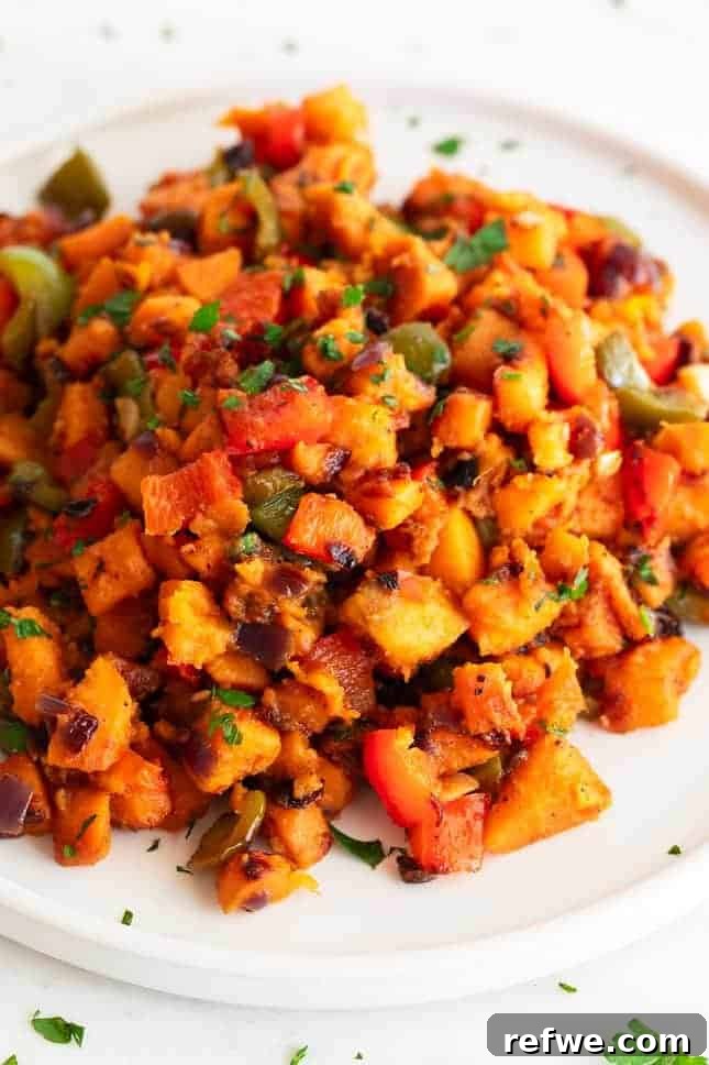 Quick Nutritious Morning Meals 14 sweet potato hash topped with fresh herbs on a white plate