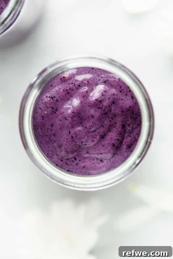 Quick Nutritious Morning Meals 17 glass cup of healthy breakfast blueberry smoothie surrounded with white flowers