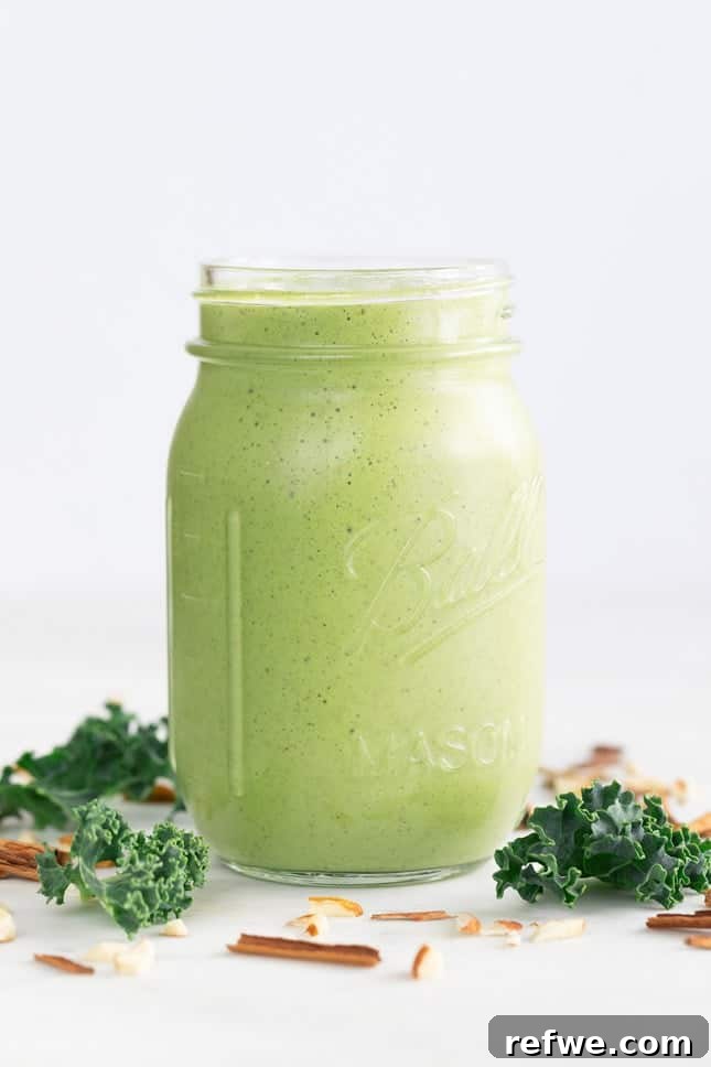 Quick Nutritious Morning Meals 19 glass mason jar of healthy green breakfast smoothie surrounded by kale and almond slivers on a white background