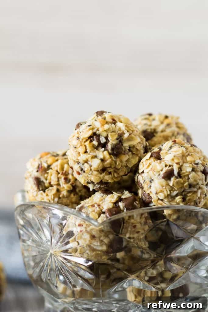 Quick Nutritious Morning Meals 6 healthy breakfast energy bites made of balls of oats with chocolate chips and peanut butter, in a glass crystal bowl