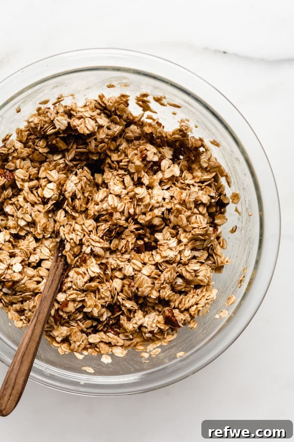 Spiced Banana Bread Granola 6 Another view of the clear mixing bowl, now with the granola mixture fully combined and ready for baking.