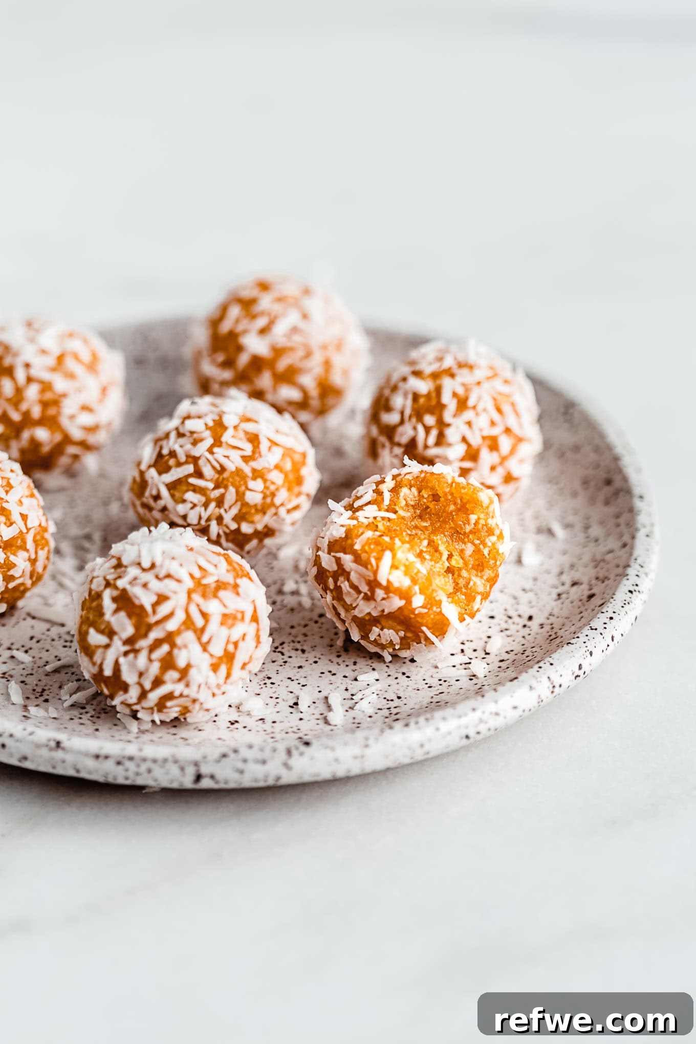Sun Kissed Apricot Coconut Power Bites 2 A vibrant plate of golden Coconut Apricot Energy Balls, ready to be enjoyed as a healthy snack or treat.