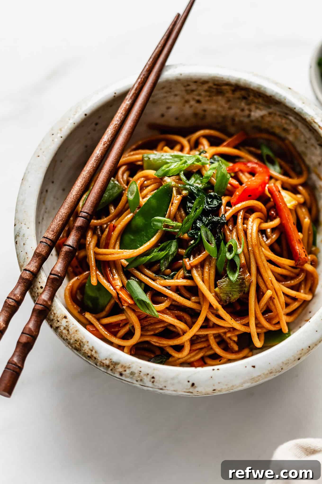 Quick Healthy Vegetable Lo Mein 9 Chinese noodles in a bowl with chopsticks.