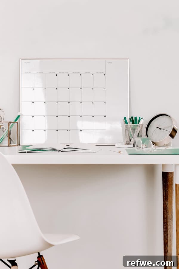 Design Your Content Calendar To Reclaim Your Time 2 A calendar and notebook on a white desk representing organized content planning