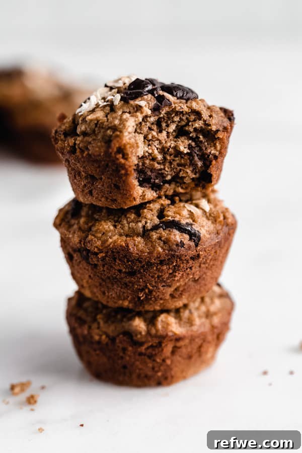 Portable Oat Cups 10 A clean, close-up stack of three baked oatmeal cups, showing their rich texture and inviting appearance.