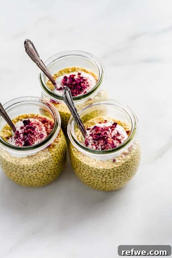 Golden Glow Chia Pudding 2 Three jars of golden milk latte chia pudding topped with creamy yogurt and delicate rose petals, ready to be enjoyed.