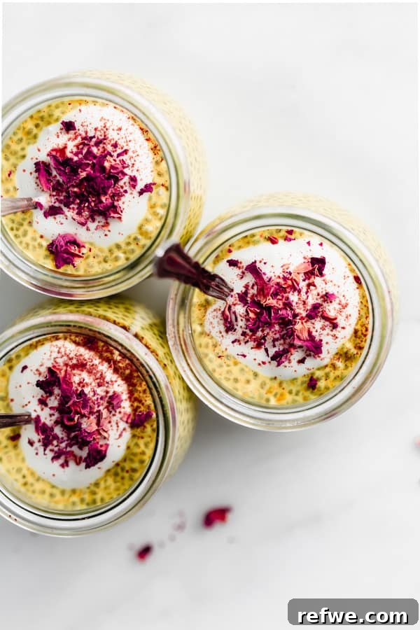 Golden Glow Chia Pudding 4 A close-up, top-down view of a single jar of golden milk chia pudding, elegantly topped with a dollop of vegan yogurt and delicate rose petals, showcasing its aesthetic appeal.