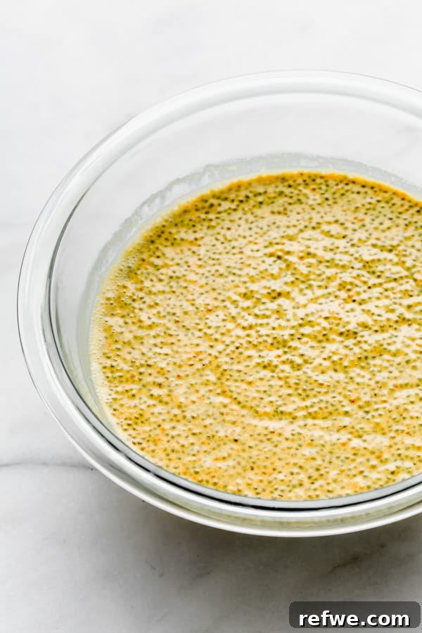 Golden Glow Chia Pudding 8 A clear mixing bowl filled with the fully combined and vibrant golden milk latte chia pudding, ready for refrigeration.