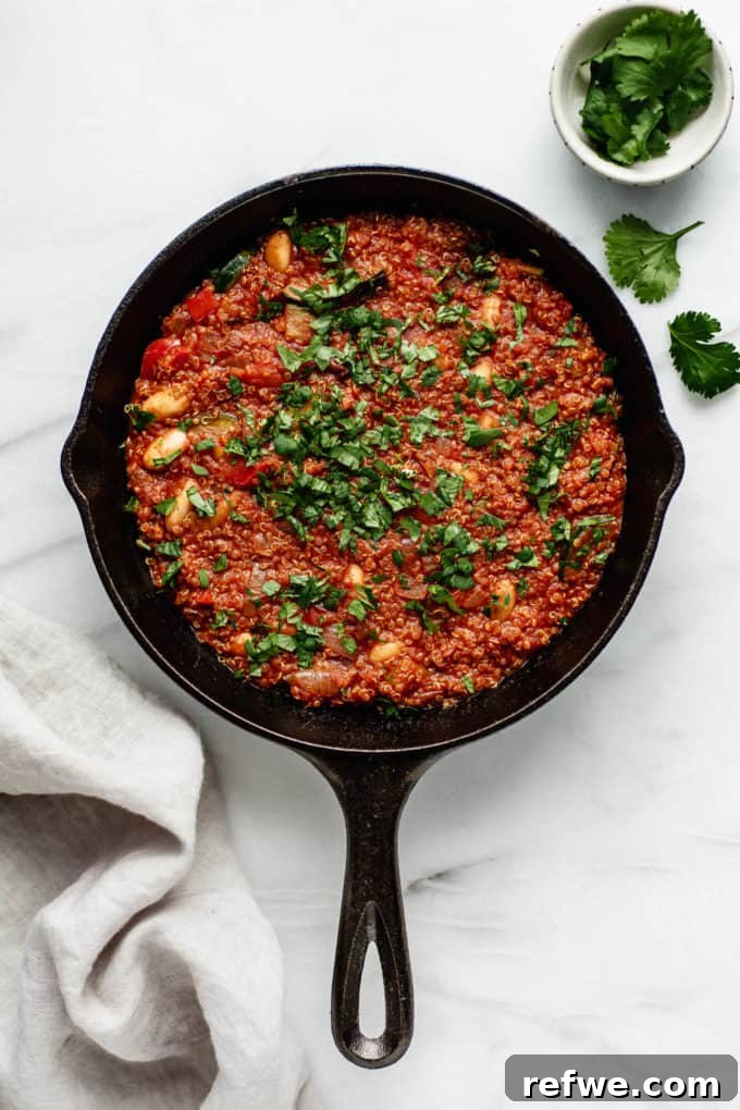Hearty Vegan Shakshuka 2 A vibrant vegan shakshuka in a cast iron skillet, generously garnished with fresh parsley, ready to be served for a hearty breakfast.